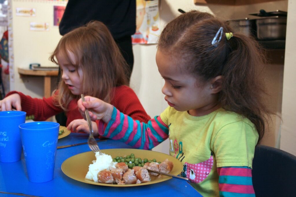Children enjoying food from a healthy nursery menu at Hunny Pot Nursery
