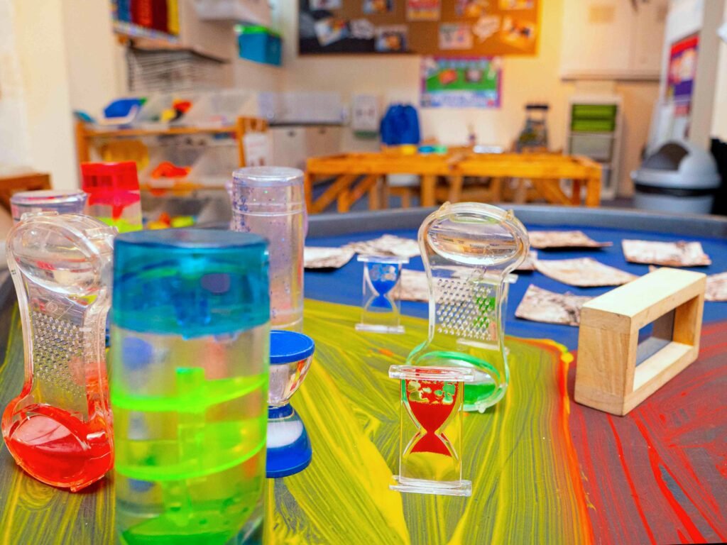 Early science resources arranged for independent exploration at Hunny Pot Nursery