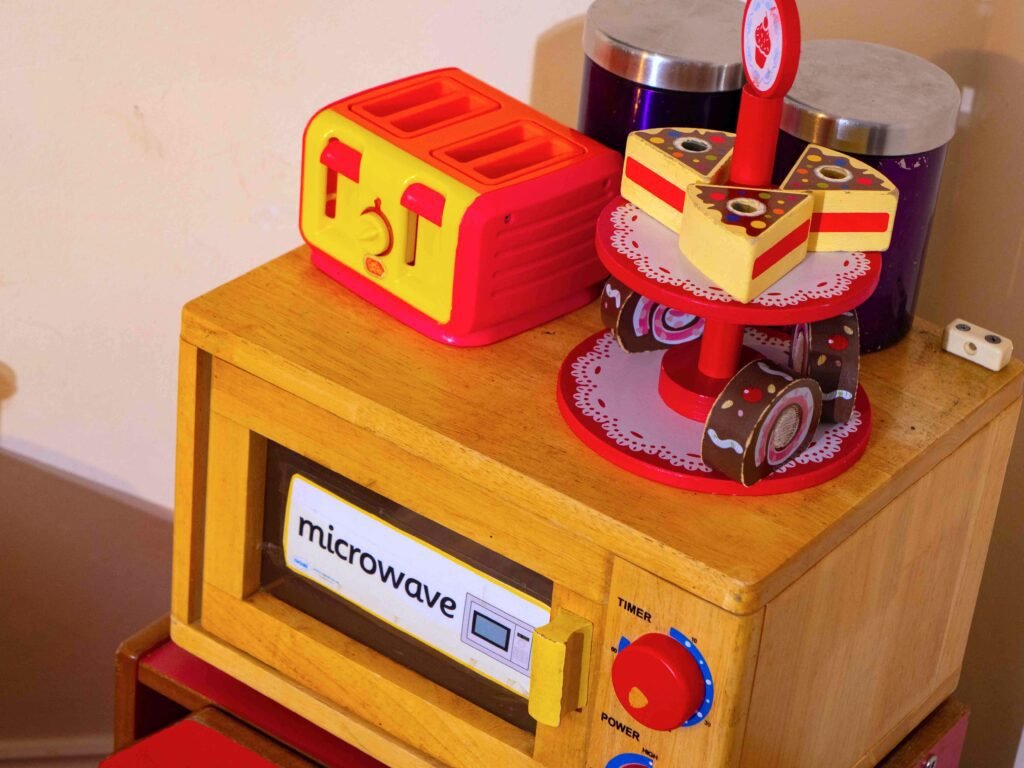 Pretend kitchen encouraging imaginative play at Hunny Pot Nursery