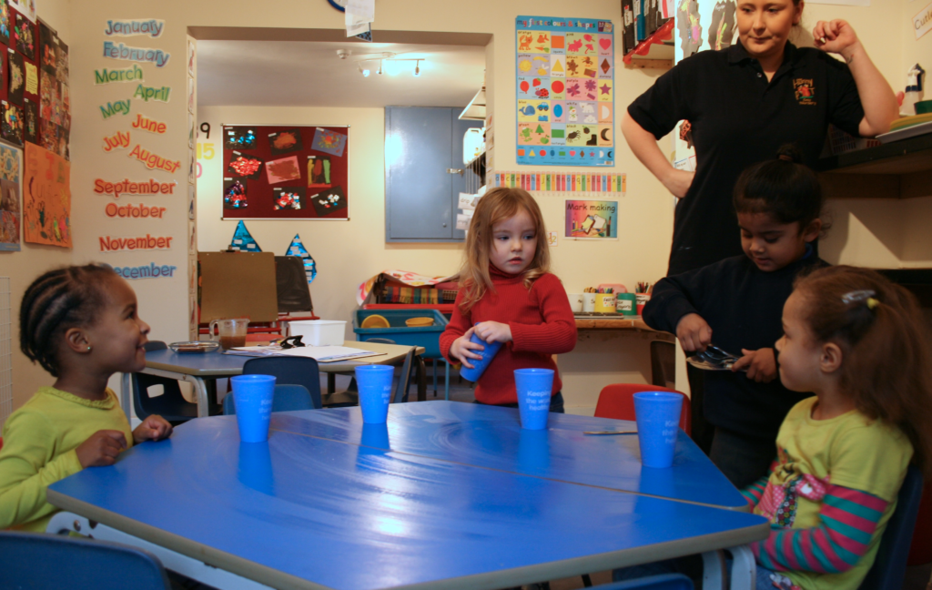 Children practising independence and social skills during a nursery routine