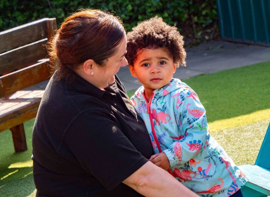 Nursery practitioner supporting and reassuring a child at Hunny Pot Nursery