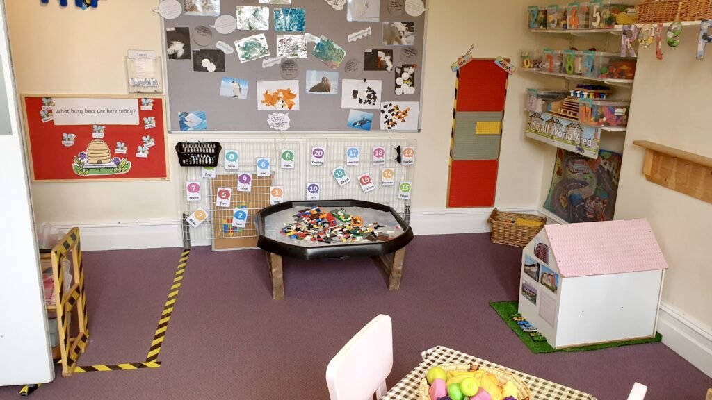 Organised nursery classroom with clear play areas and accessible resources at Hunny Pot Nursery