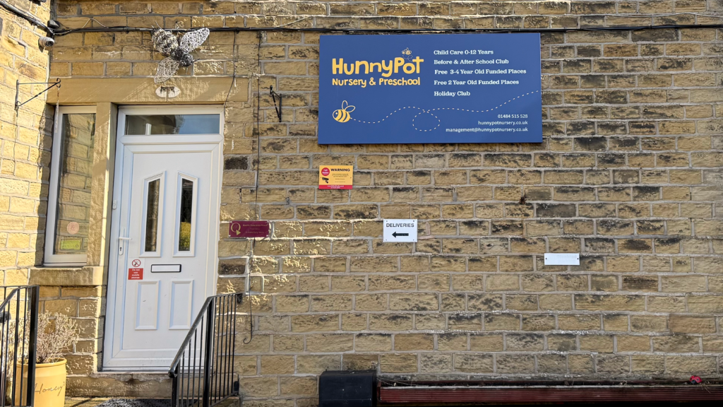 Hunny Pot Nursery entrance and sign advertising funded childcare places
