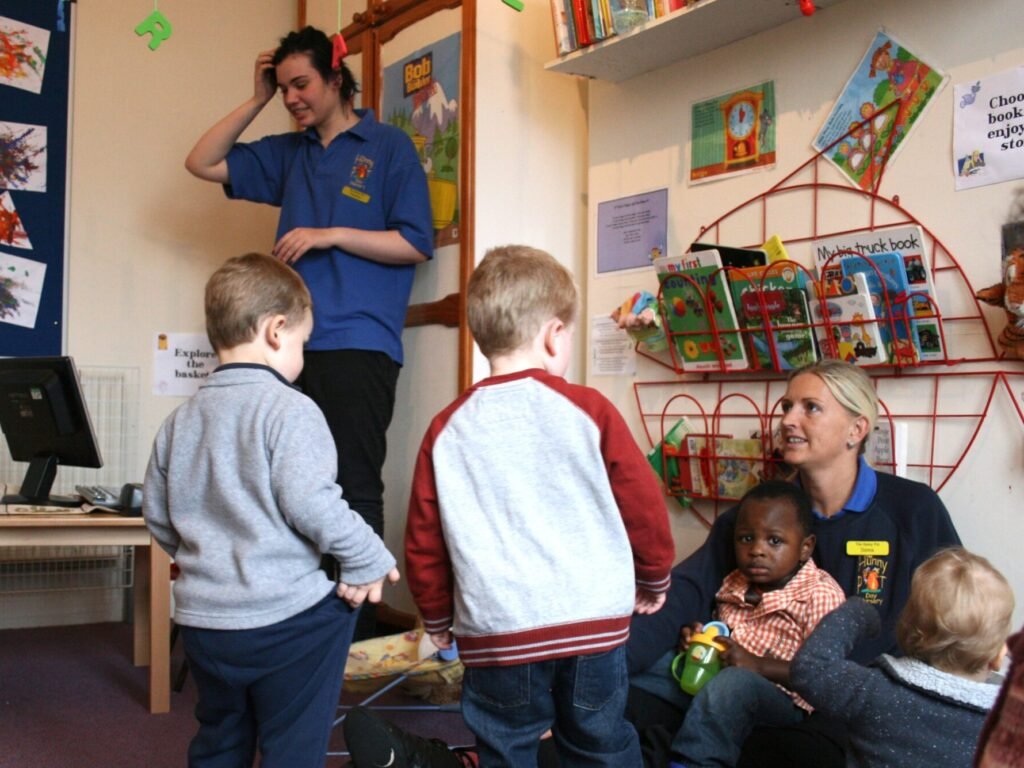 Children taking part in a familiar group routine at Hunny Pot Nursery
